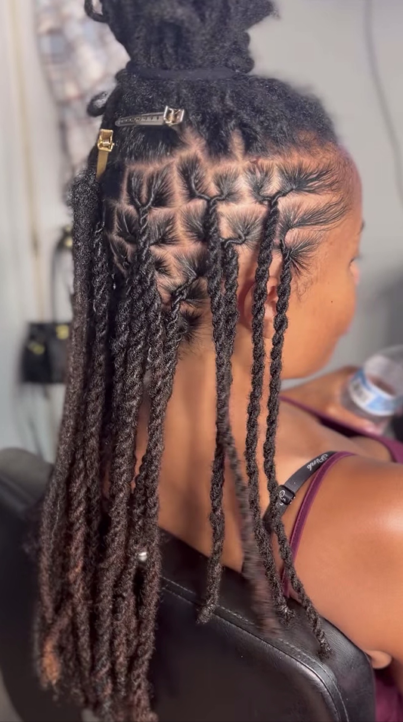 Close view of the detailed parting and twists during styling